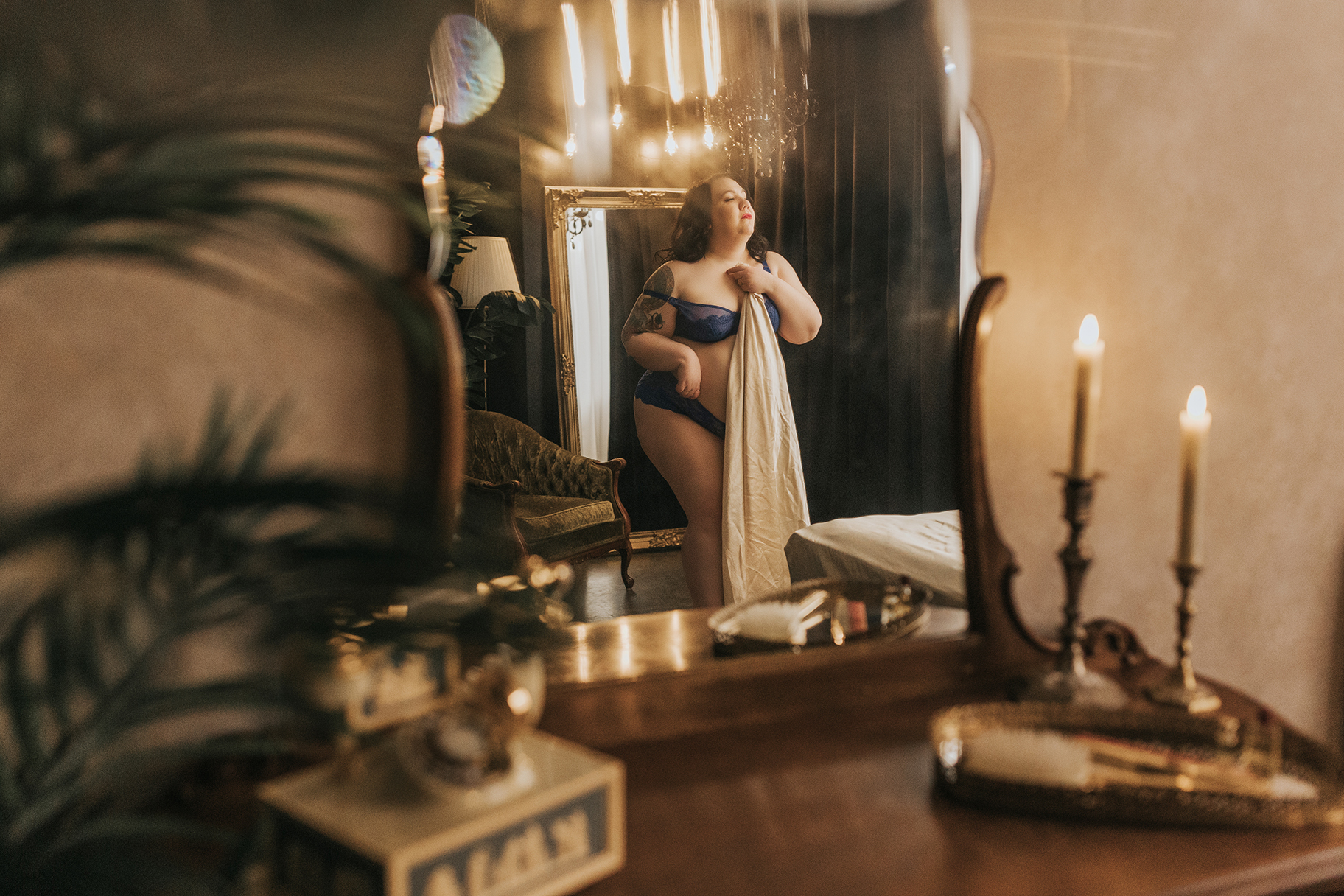 beautiful plus size woman posing in vintage inspirited boudoir studio in vancouver BC