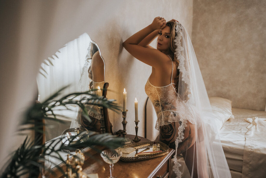 woman leaning on wall wearing bridal veil in vancouver boudoir studio